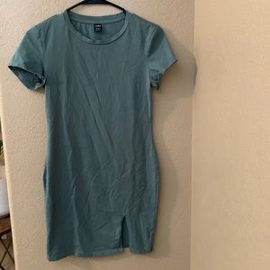 Green tight dress, small slit